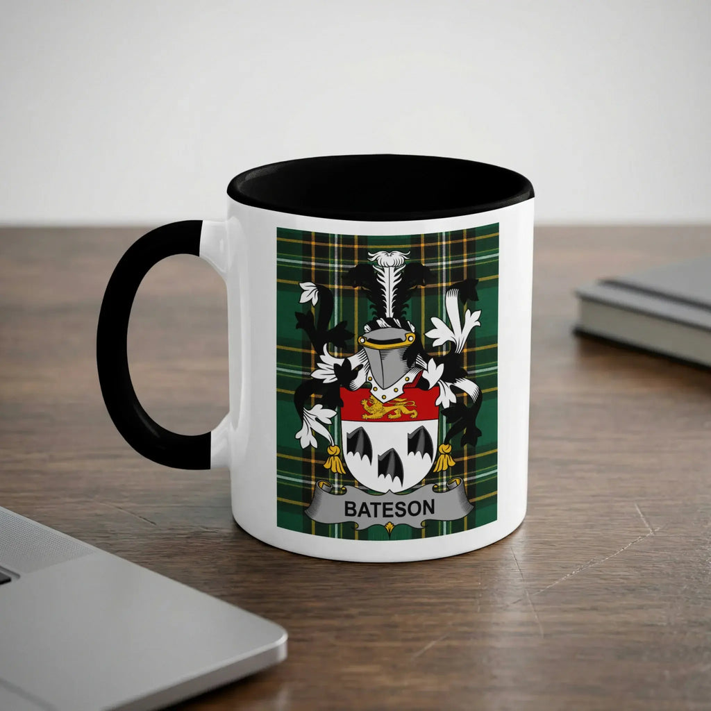 White mug with black handle featuring the Bateson family crest on a tartan background.