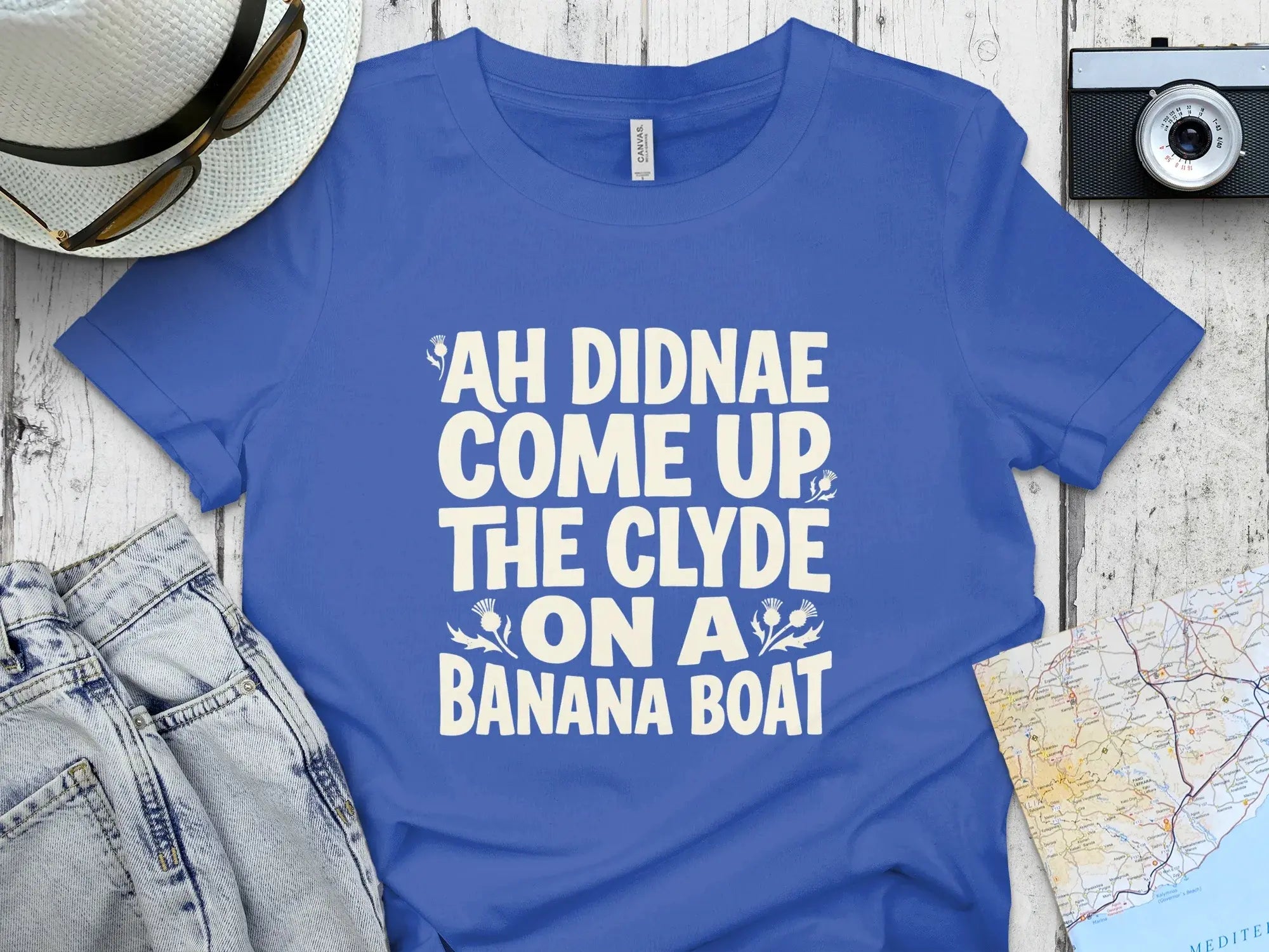 Blue t-shirt with white text that reads "Ah didnae come up the Clyde on a banana boat."