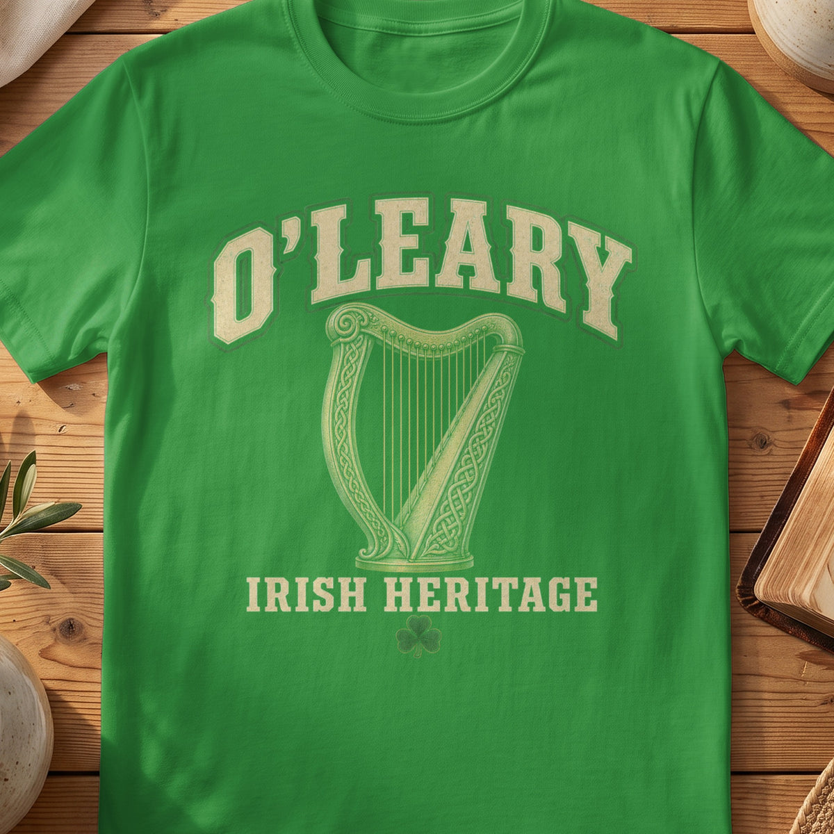 O'Leary Irish harp T-shirt in Irish Green, with cream surname lettering, a gold-toned harp, green shamrock and “Irish Heritage” text.