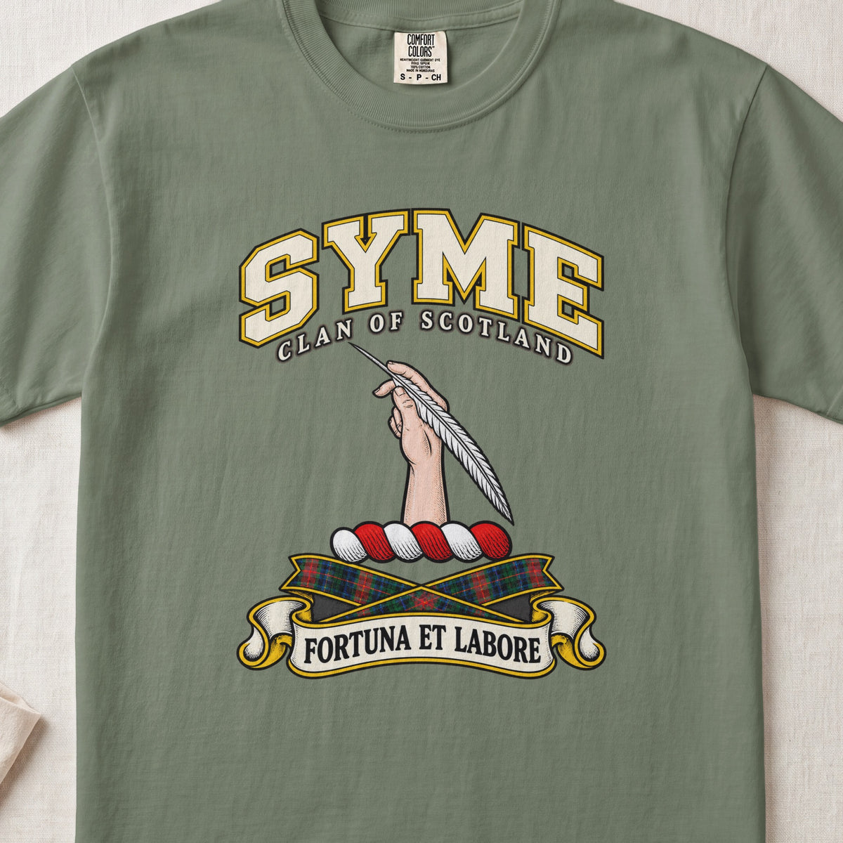 Syme Scottish clan T-shirt in Moss, front view with a hand holding a feather and motto design.