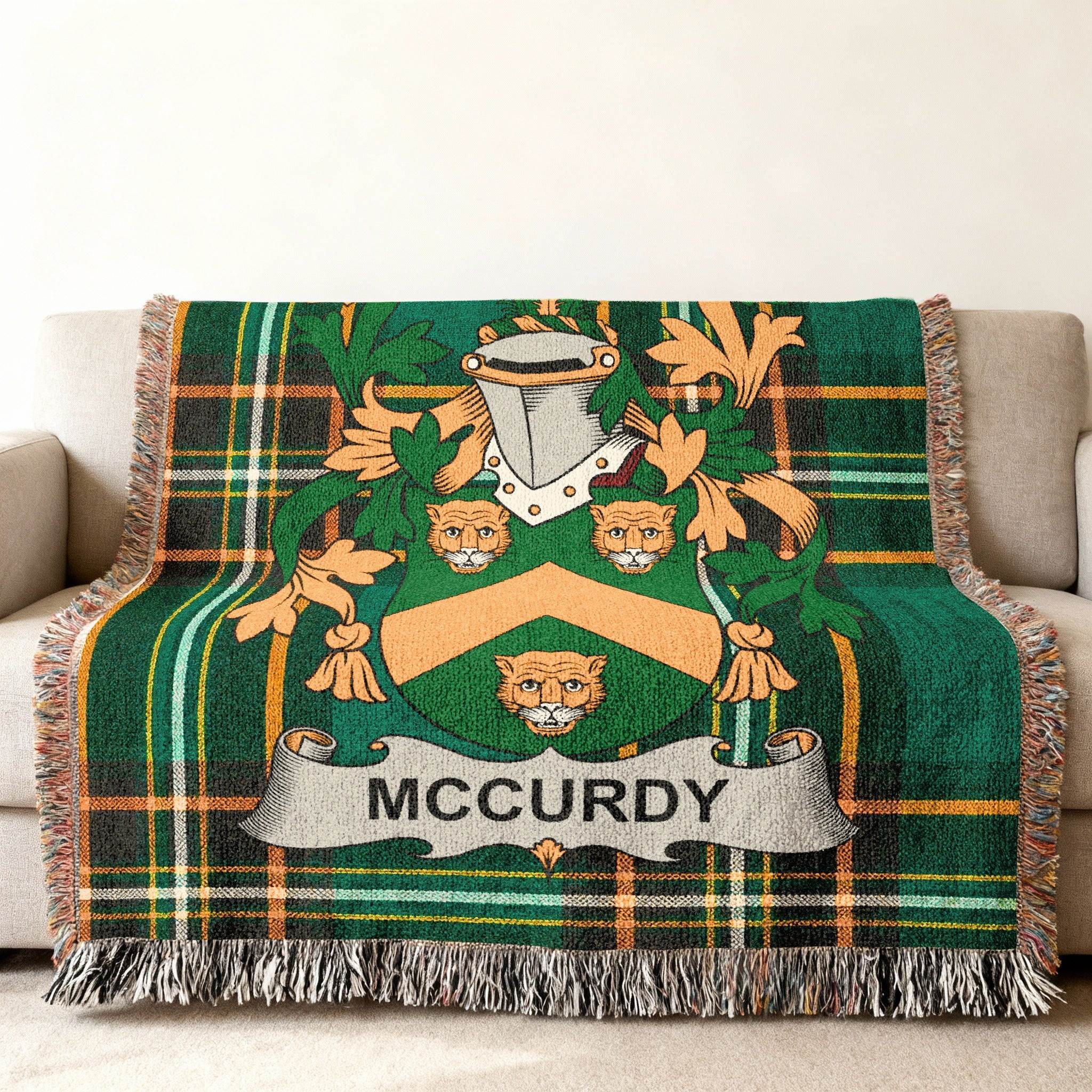 McCurdy family crest displayed on a green tartan woven throw blanket.