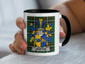 White mug with black rim featuring a green tartan pattern and a family crest.
