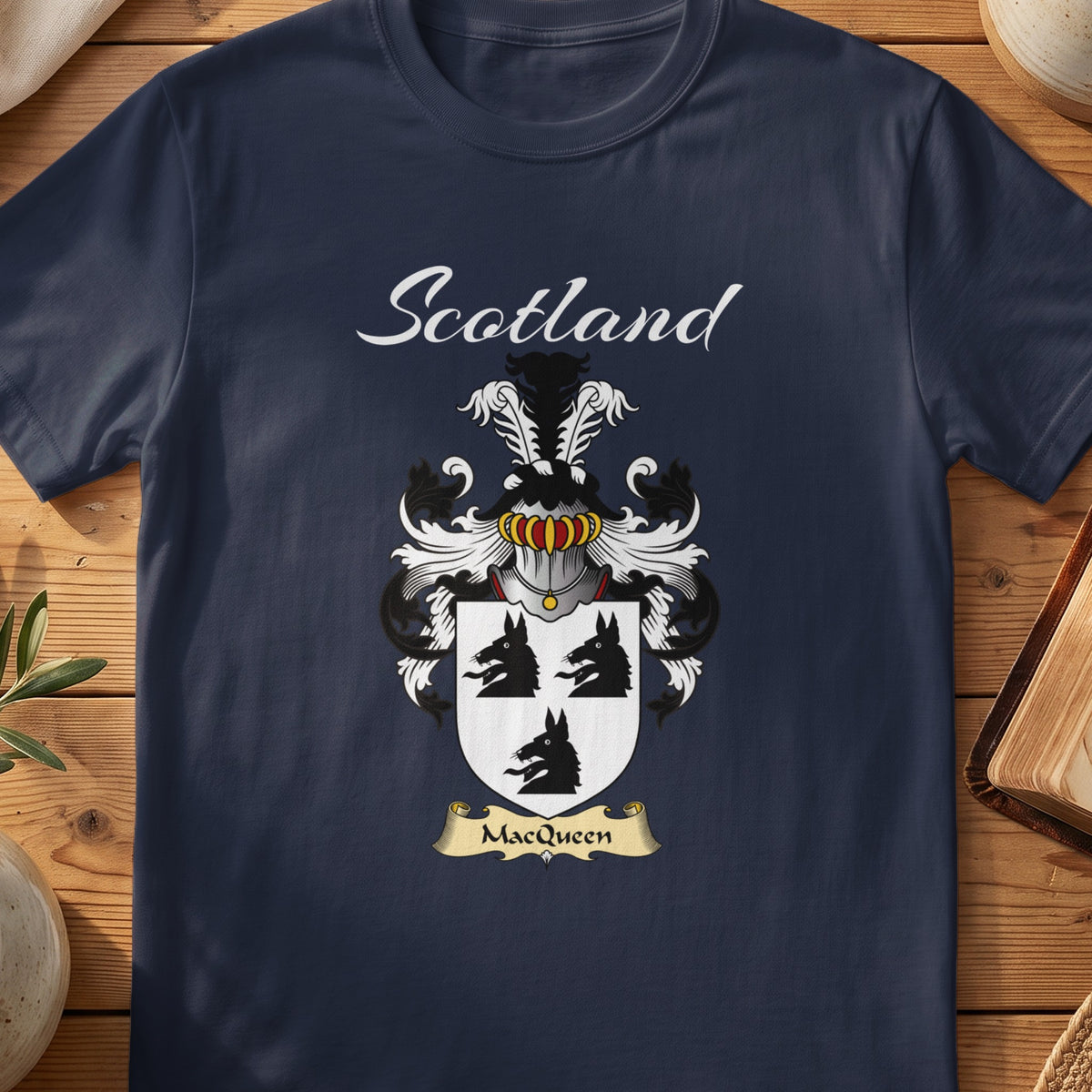 Navy MacQueen family shield T-shirt featuring three black animal heads on a pale shield