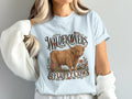 Model wearing the Wildflowers & Fluffy Cows Highland cow Comfort Colors T-shirt in Chambray