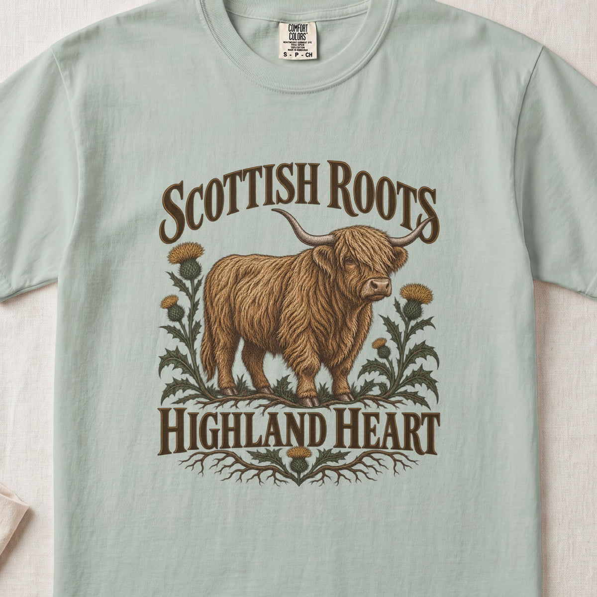 Scottish Roots, Highland Heart Highland cow design on a Bay Comfort Colors 1717 T-shirt, flat lay
