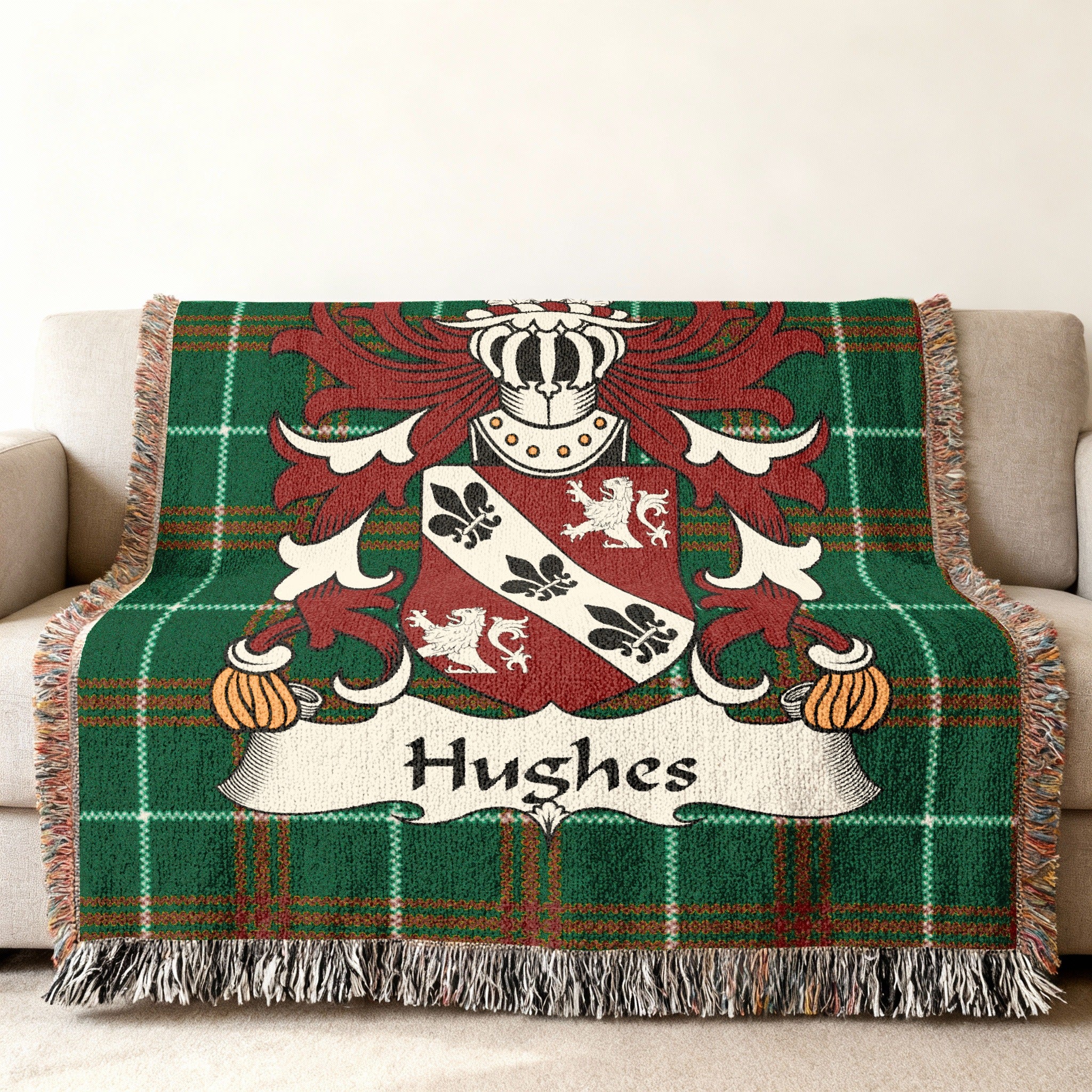 Hughes family crest on a green plaid throw blanket with fringe.