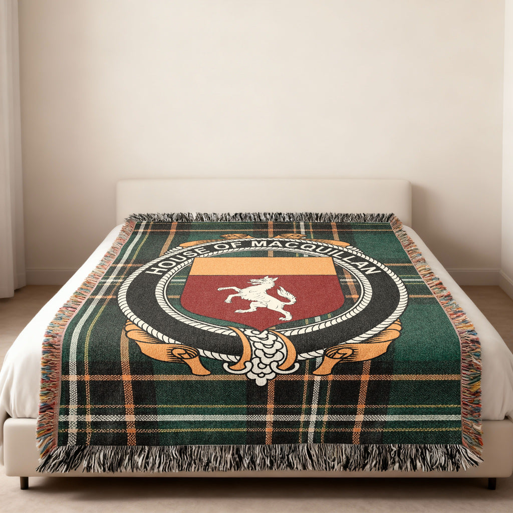 MacQuillan family crest emblem woven blanket displayed on a bed