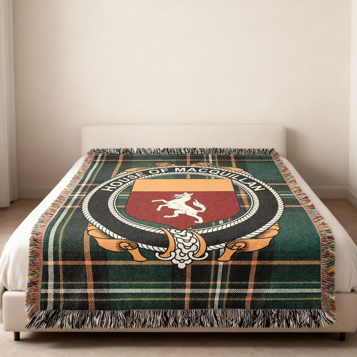 MacQuillan family crest emblem woven blanket displayed on a bed