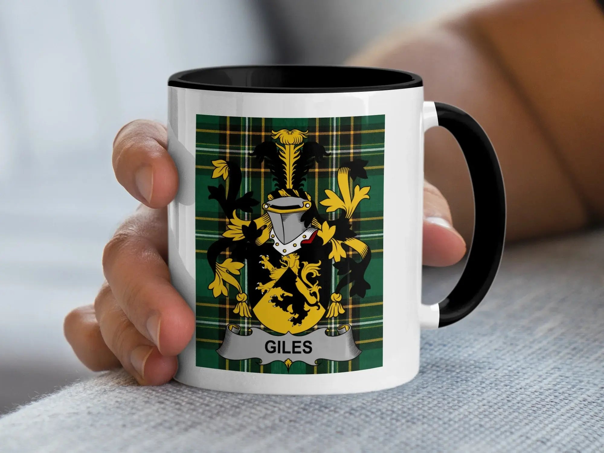 White mug with black rim featuring a green tartan pattern and the Giles family crest.