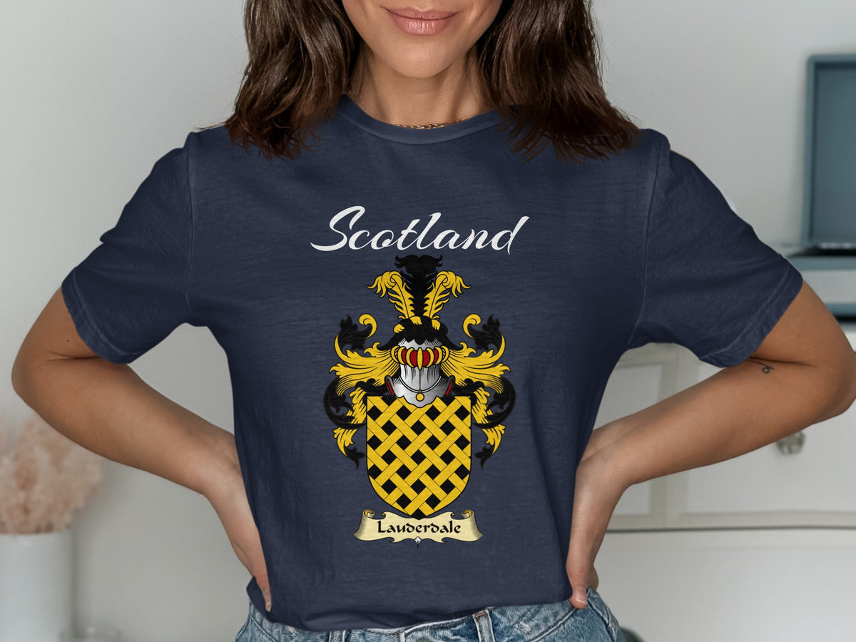 Model wearing a navy Lauderdale T-shirt featuring a gold lattice pattern on a black shield