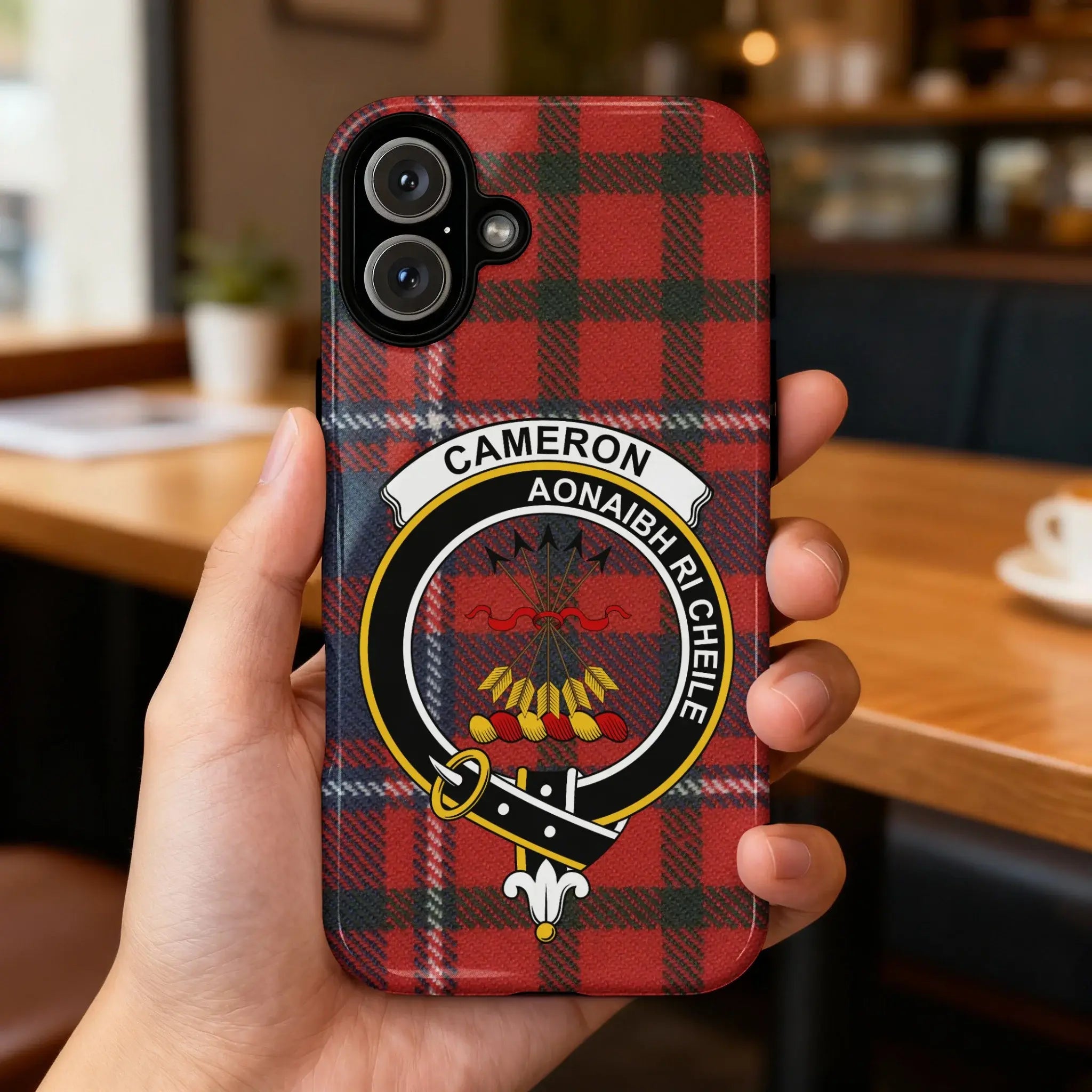 Cameron clan crest phone case on iPhone — slim profile, precise port cutouts, red tartan