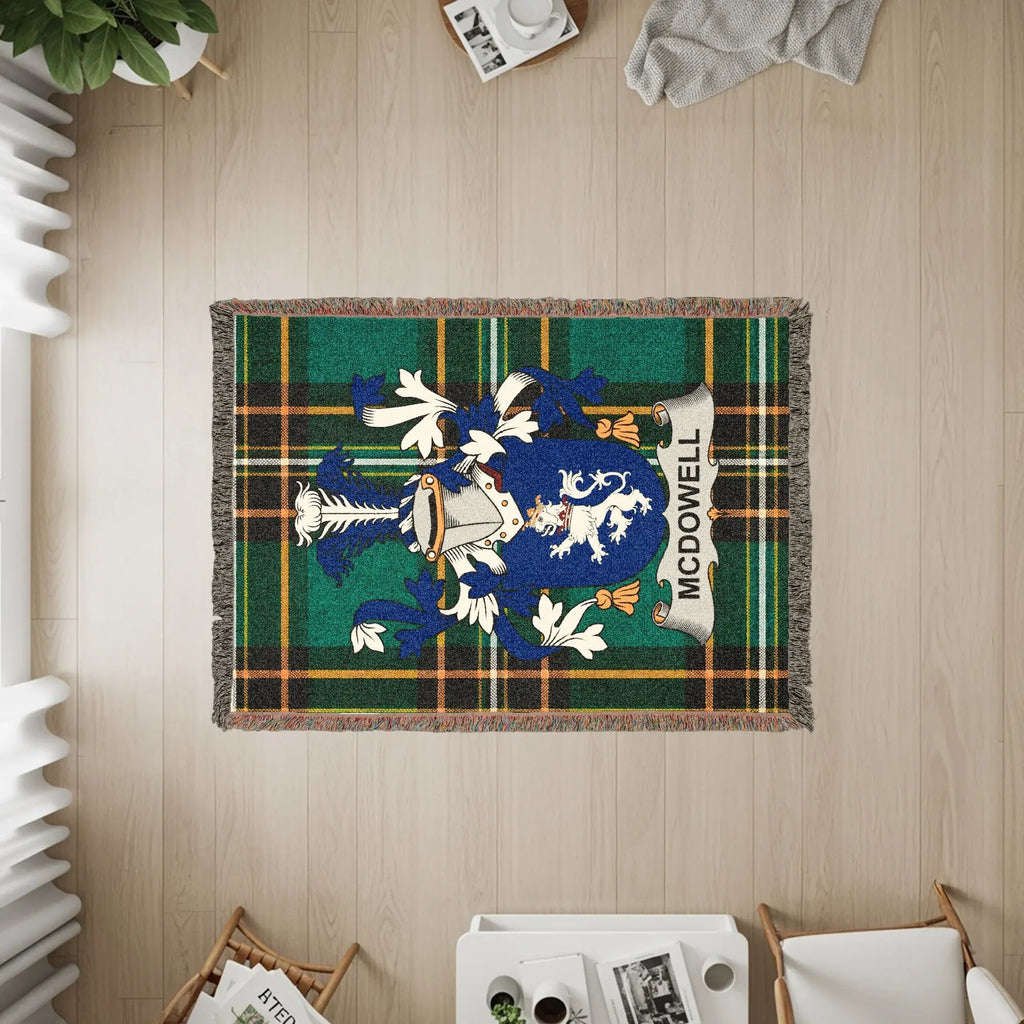 McDowell family crest on a green and blue plaid woven throw blanket.