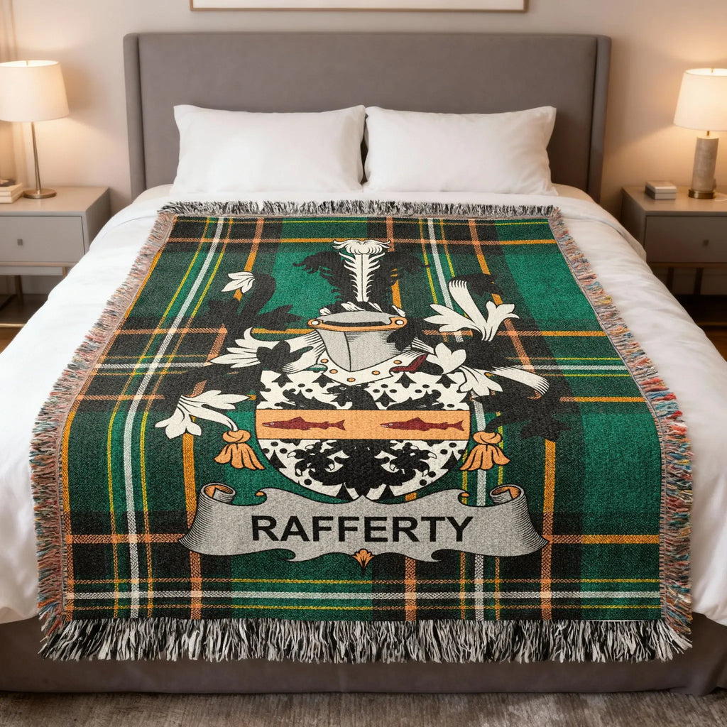 Tartan blanket with Rafferty coat of arms displayed on a bed.