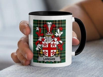 White mug with black rim featuring Langan family crest on green tartan background.