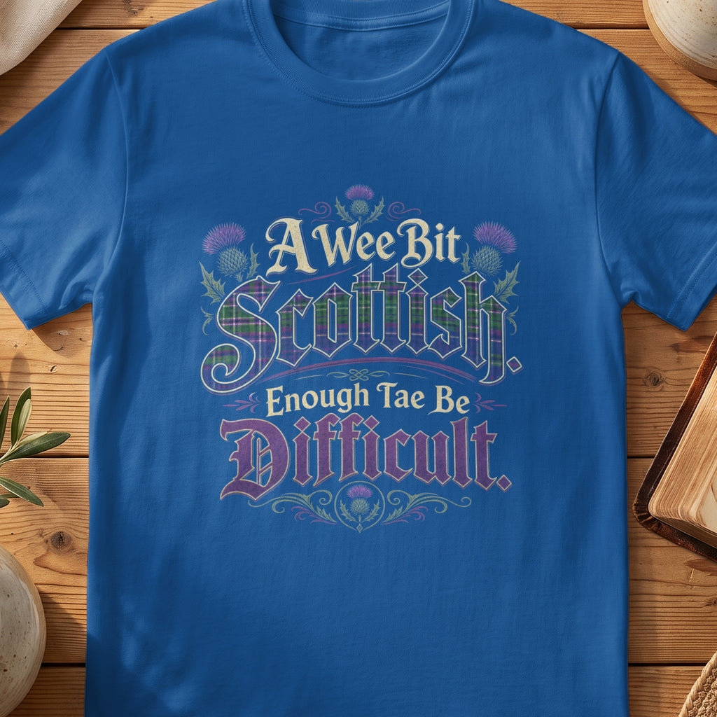 Blue t-shirt with text "A Wee Bit Scottish, Enough Tae Be Difficult" and thistle designs.