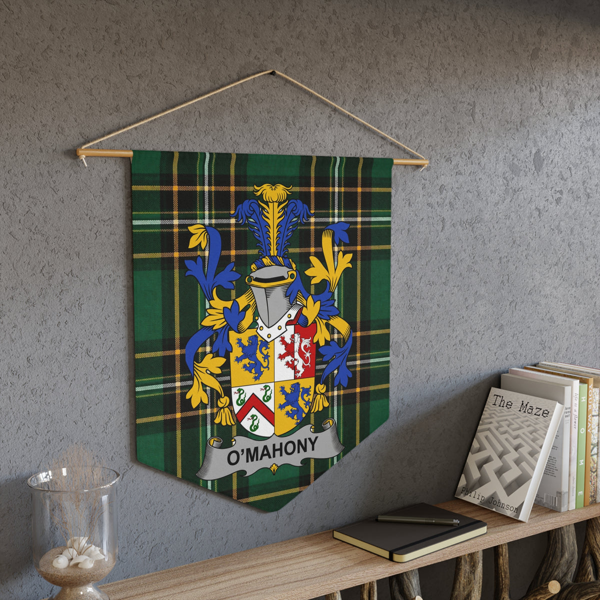 Green tartan banner with O'MAHONY coat of arms hanging on wall.