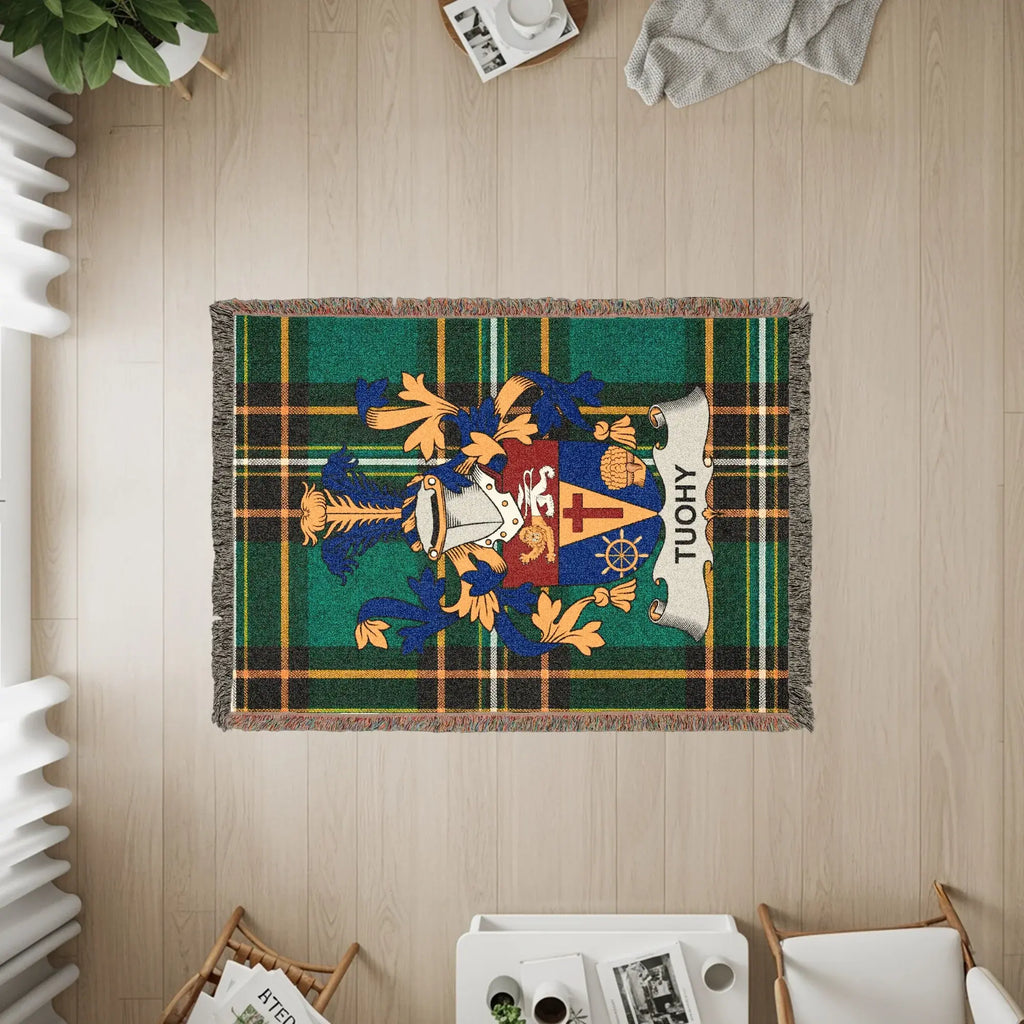 Tartan throw rug with a coat of arms and the name TUOHY.