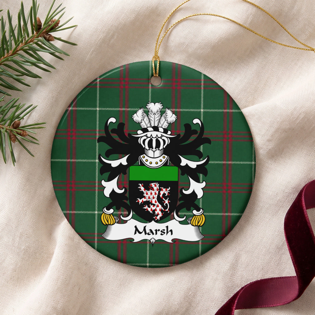 Marsh ornament on cream fabric with gold string, evergreen and burgundy ribbon; a red-and-white patterned lion on a black shield with a green top band on Welsh National Tartan.