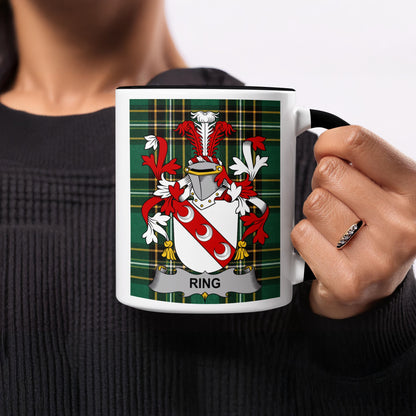 White mug with black handle and rim featuring a tartan pattern and the Ring family crest.