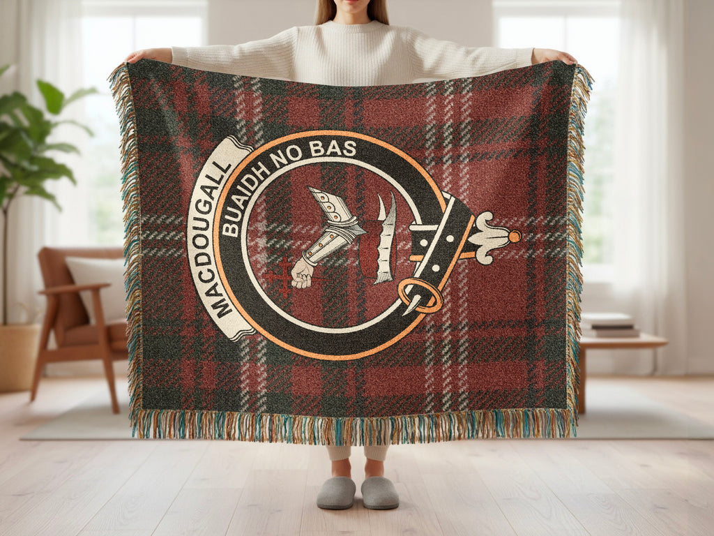 Person holding the MacDougall woven blanket to show the full design, tartan background and fringe