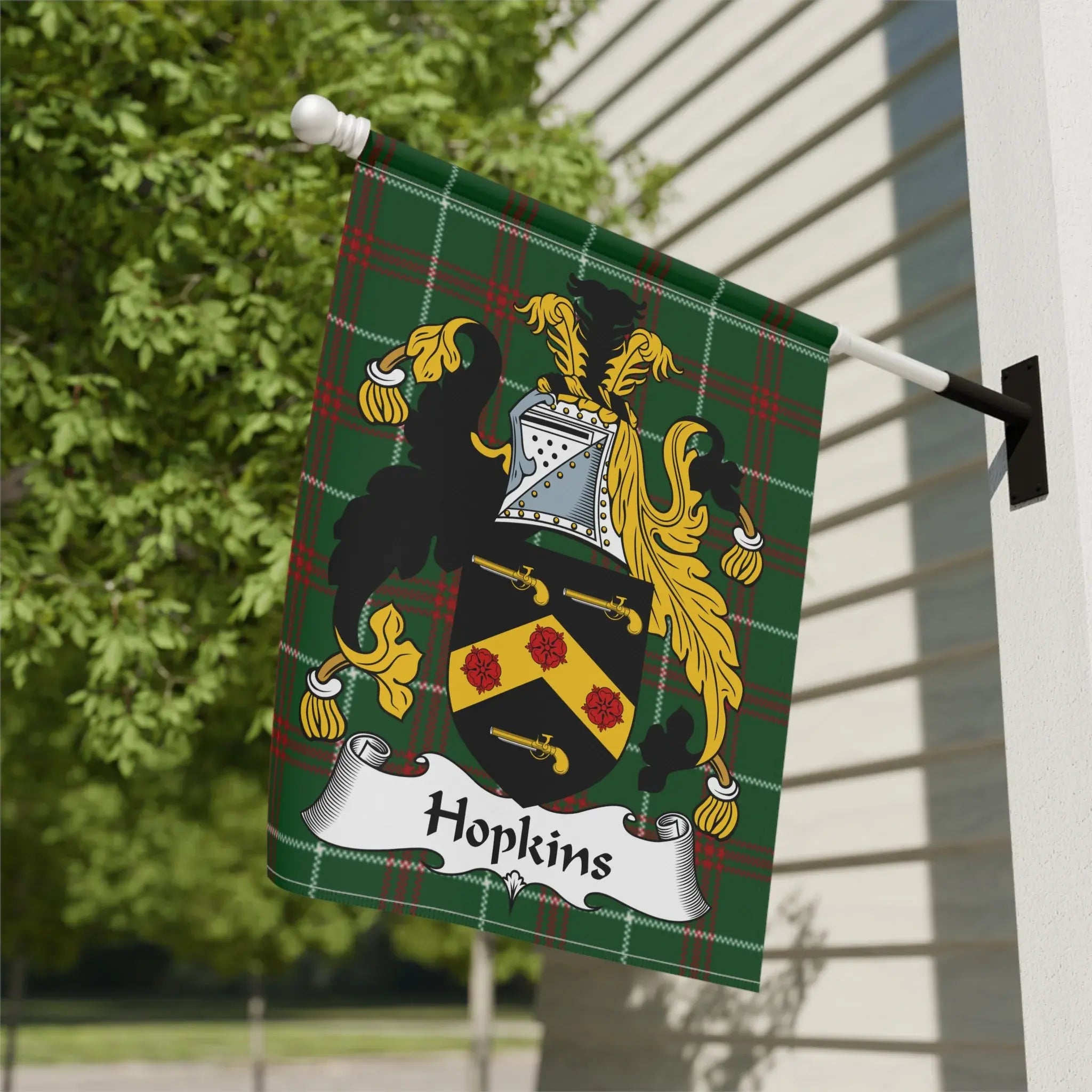 Green plaid Hopkins family crest flag with gold shield and red roses.