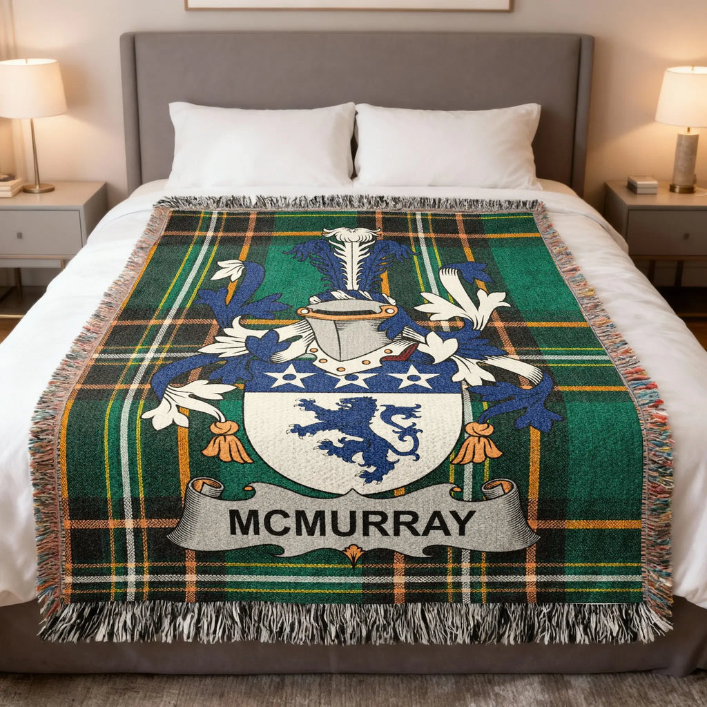 McMurray tartan blanket with coat of arms, draped on a bed.