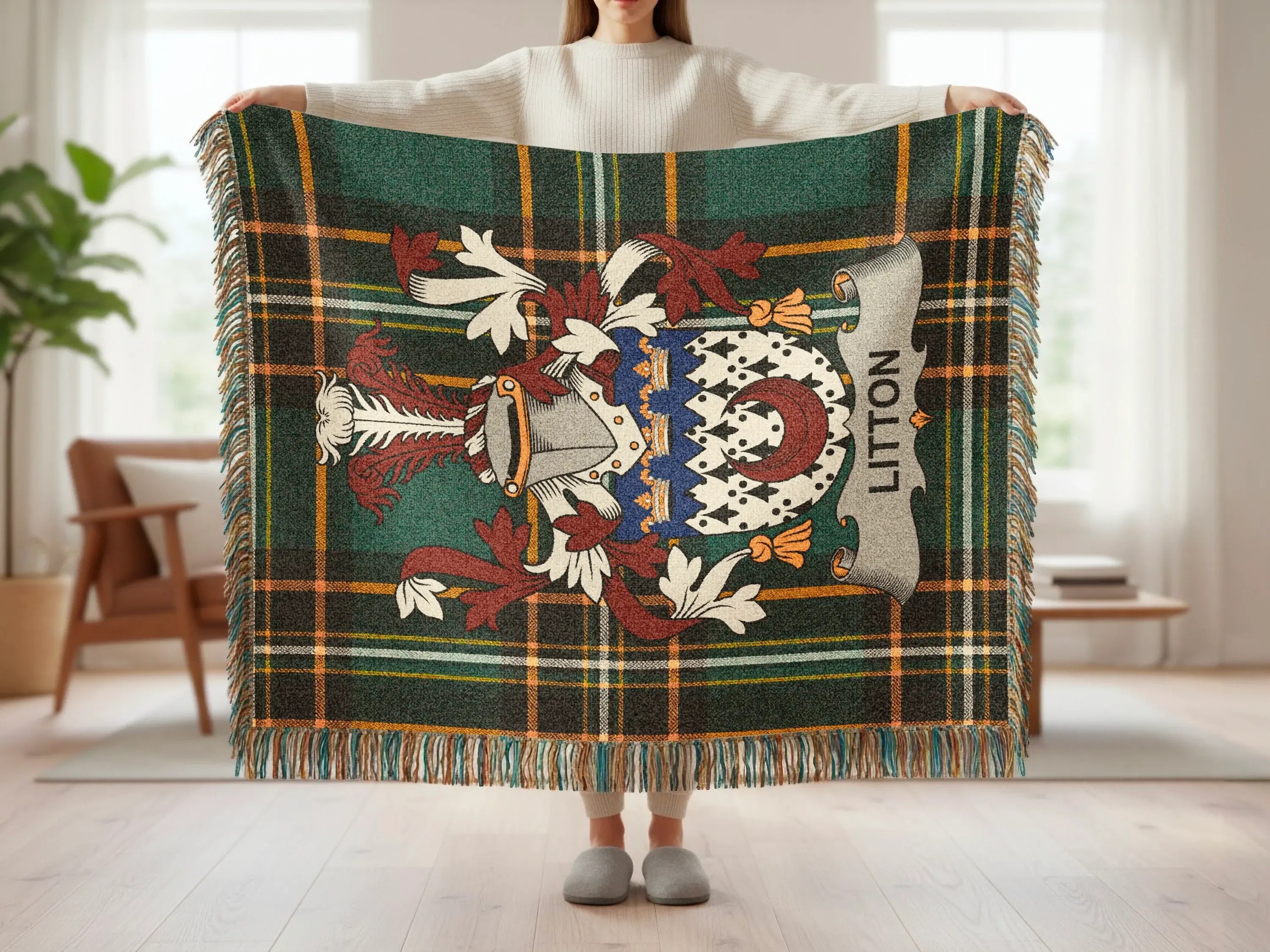 Green plaid throw blanket with heraldic crest and "Litton" text.