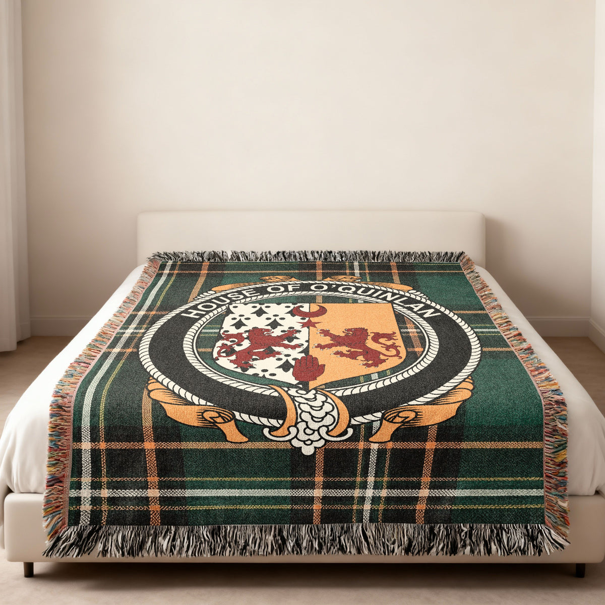 O'Quinlan family crest emblem woven blanket displayed on a bed