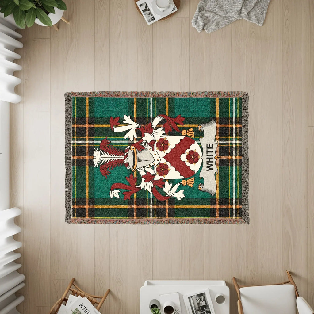 Tapestry with White family crest on green plaid background.