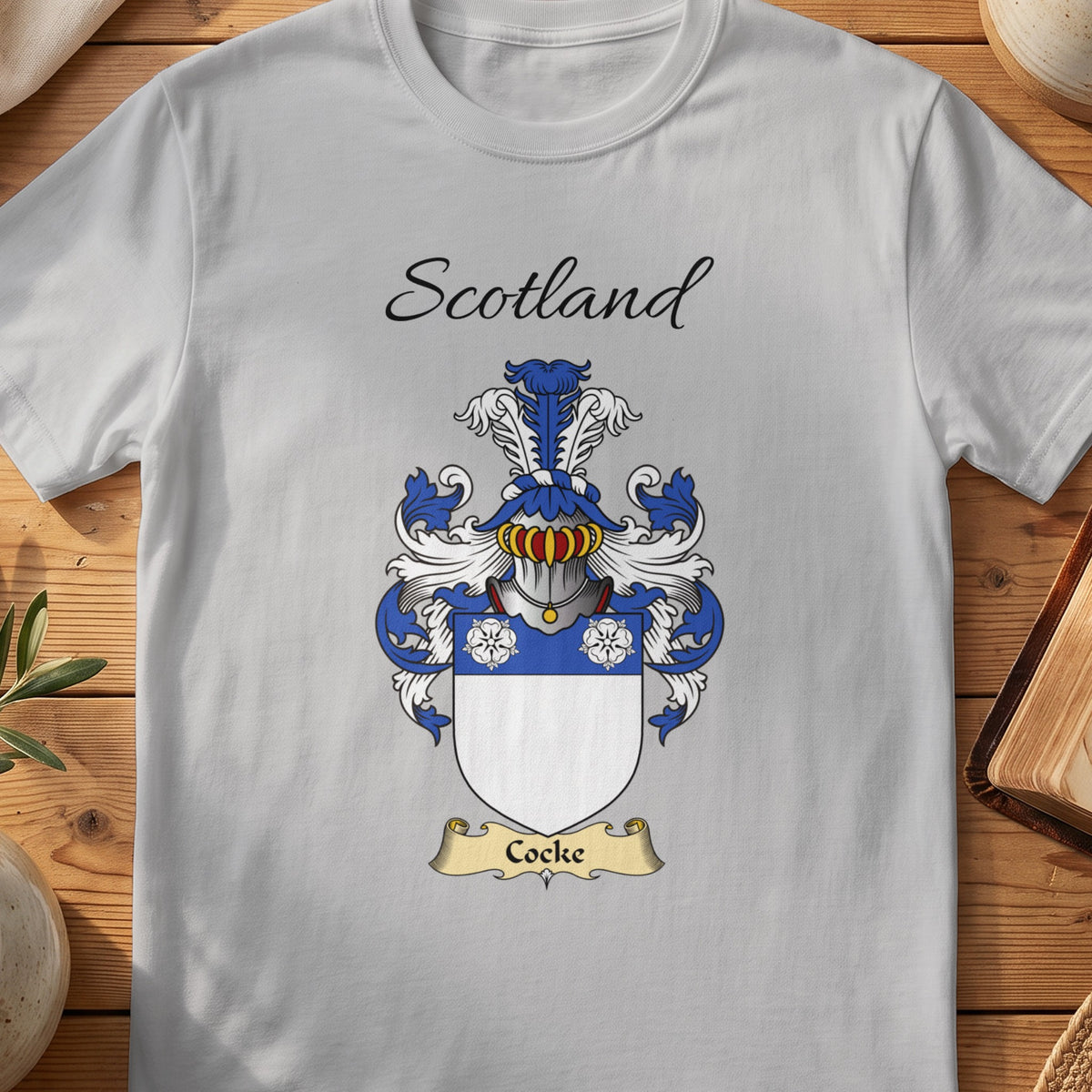 Sport Grey Cocke Scottish family shield T-shirt featuring three white flowers on a blue band