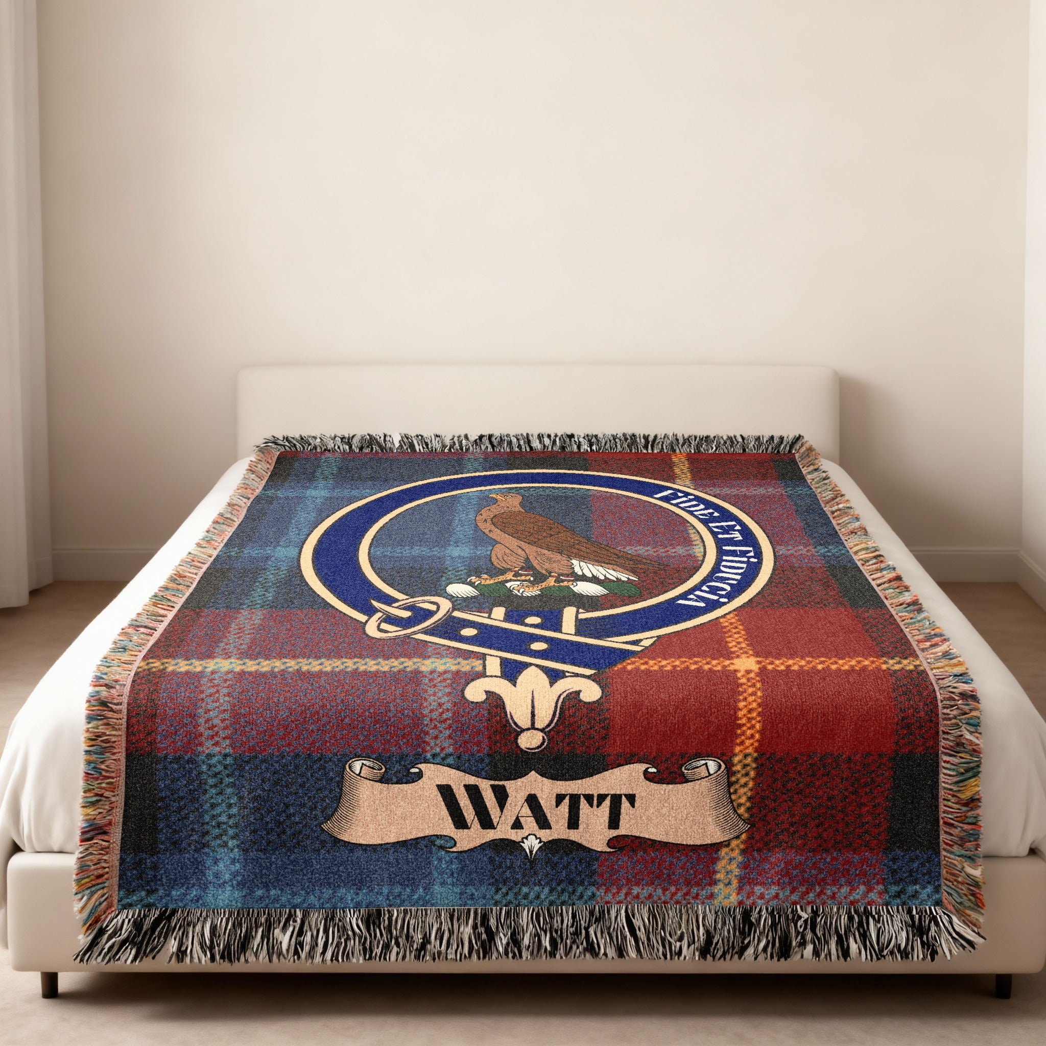 Watt family crest with rising eagle woven into tartan blanket
