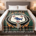 House of O'Crowley family crest woven blanket on an Irish National Tartan background, displayed on a bed