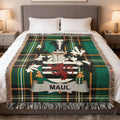 Tartan blanket with a coat of arms and the name "MAUL" displayed.