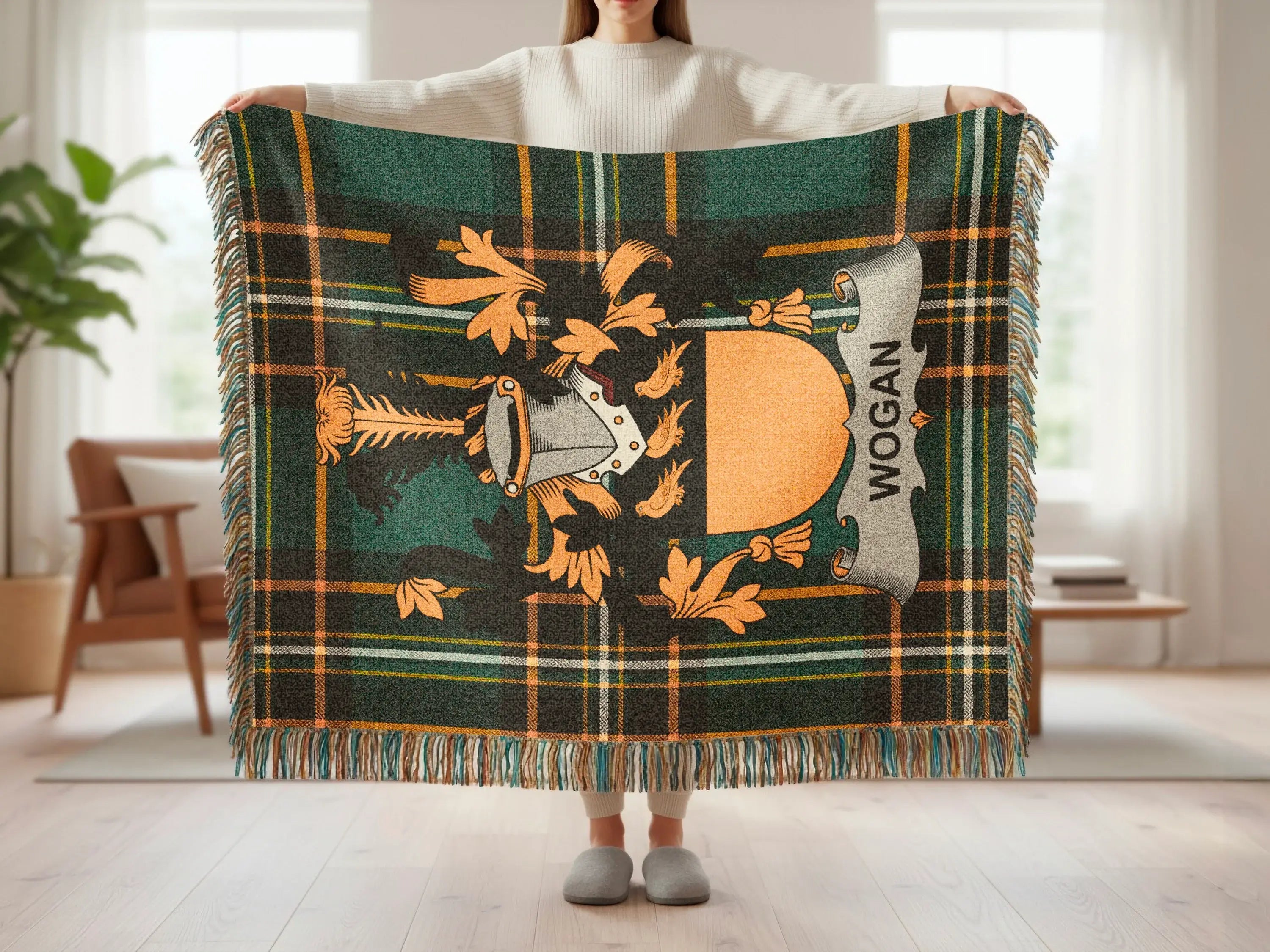 Green tartan throw with Wogan crest and fringe.