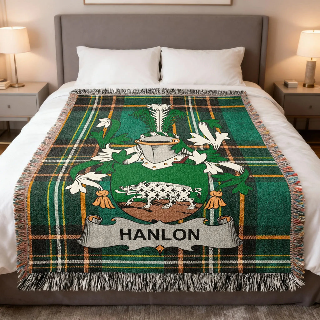 Green tartan blanket with Hanlon family crest centered on a bed.