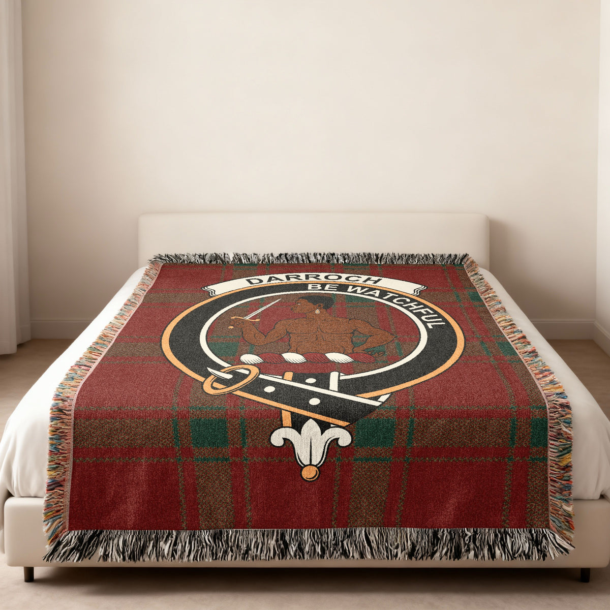 Darroch Scottish woven blanket spread across a bed, showing the full crest design and tartan background