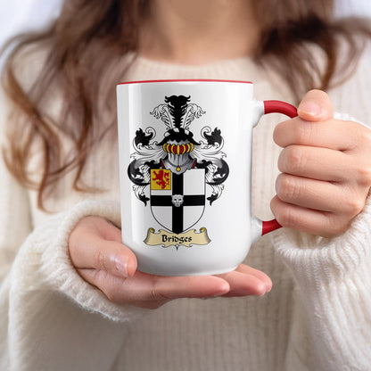 Mug with Bridges family crest held by hands.