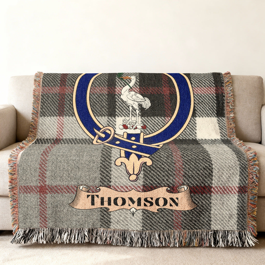Thomson clan crest woven into tartan throw blanket — close-up