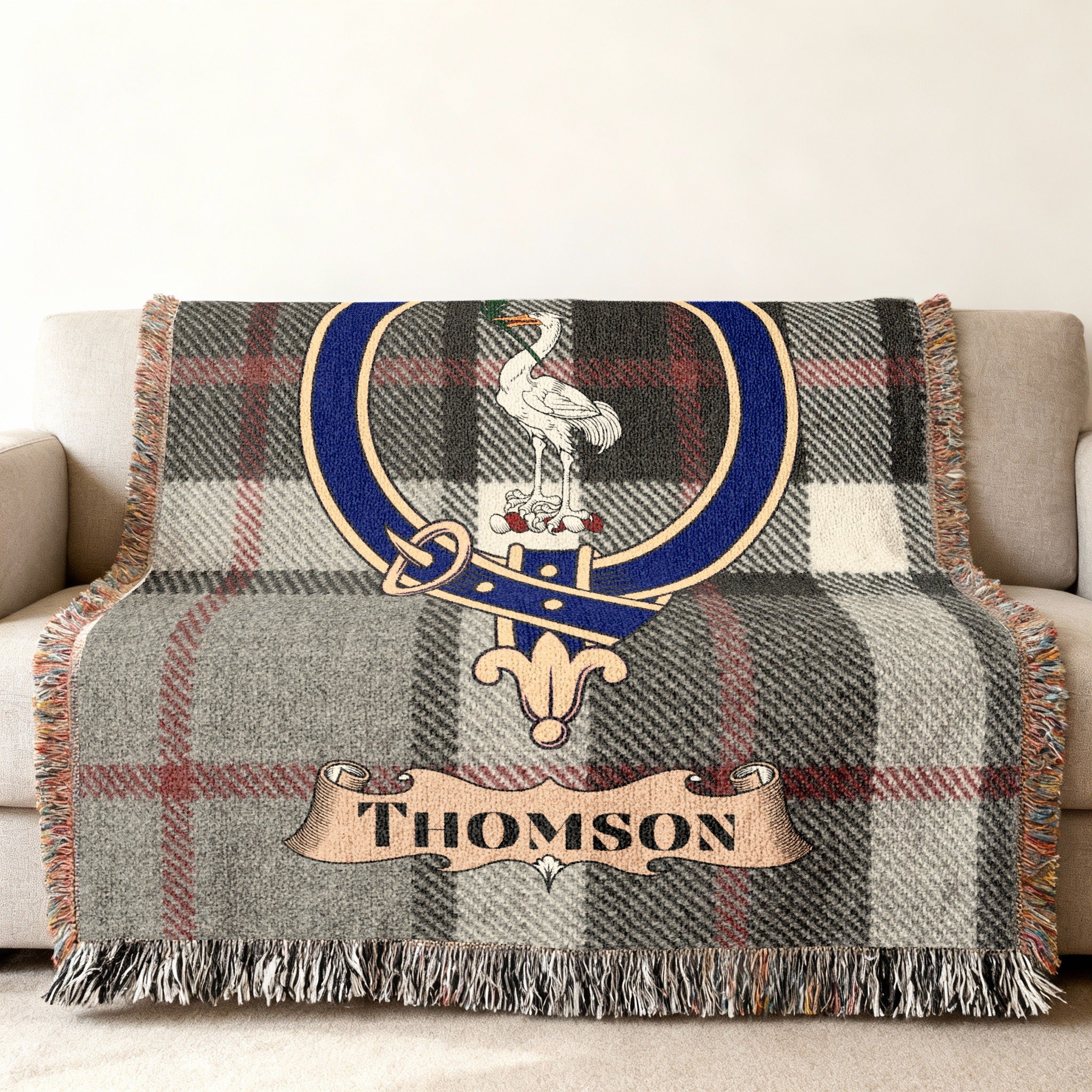 Thomson clan crest woven into tartan throw blanket — close-up