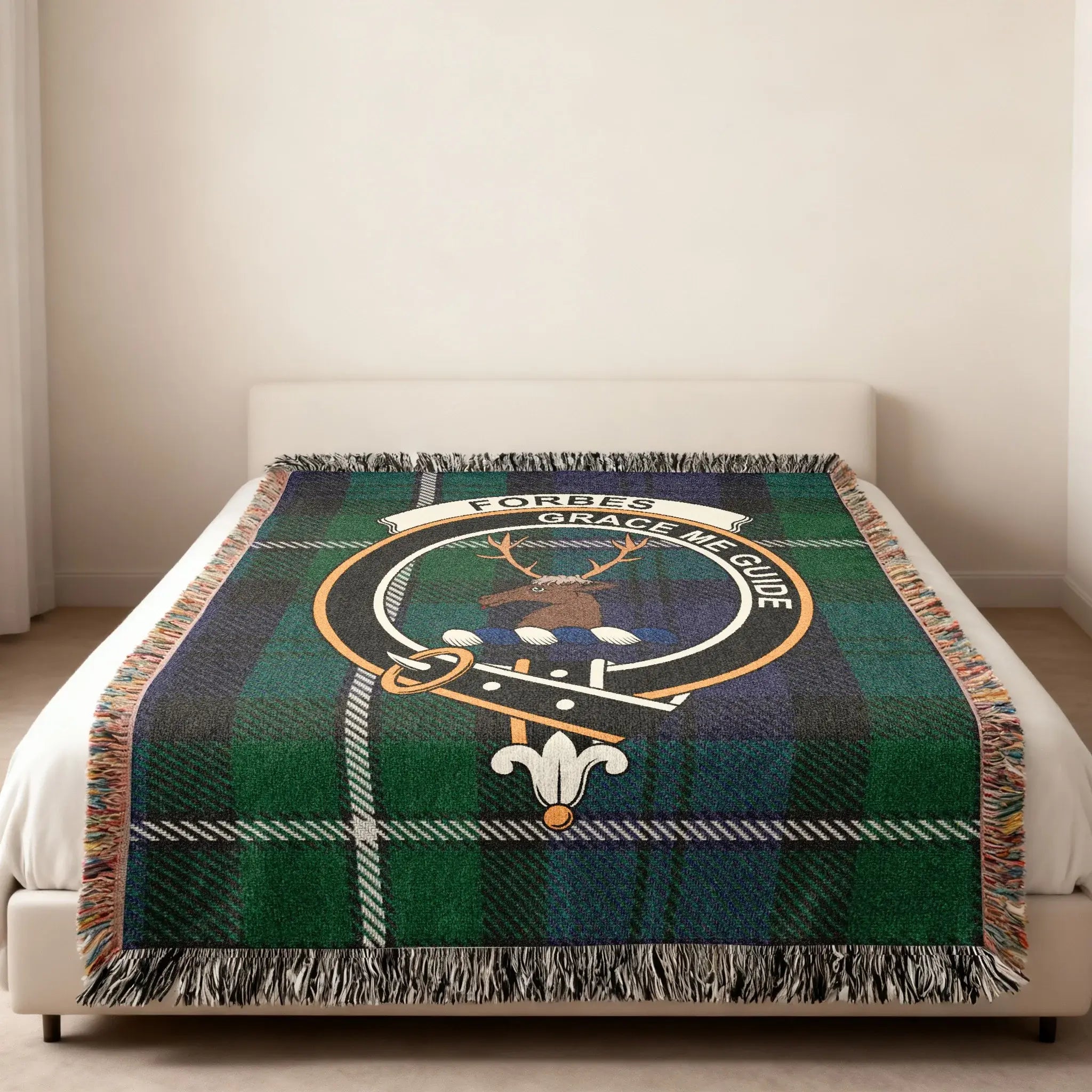 Forbes clan traditional Scottish tartan woven blanket — stag crest at centre, fringe edge visible