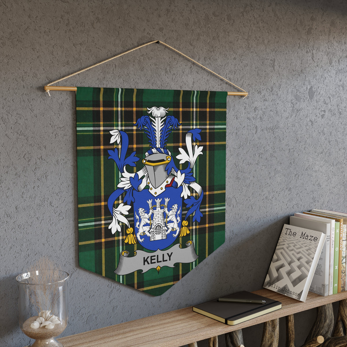 Kelly family crest on green plaid banner hanging on textured wall.