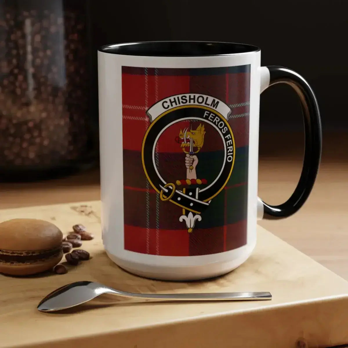 Close-up of Chisholm clan crest on 11oz mug — green-red tartan and Feros Ferio motto