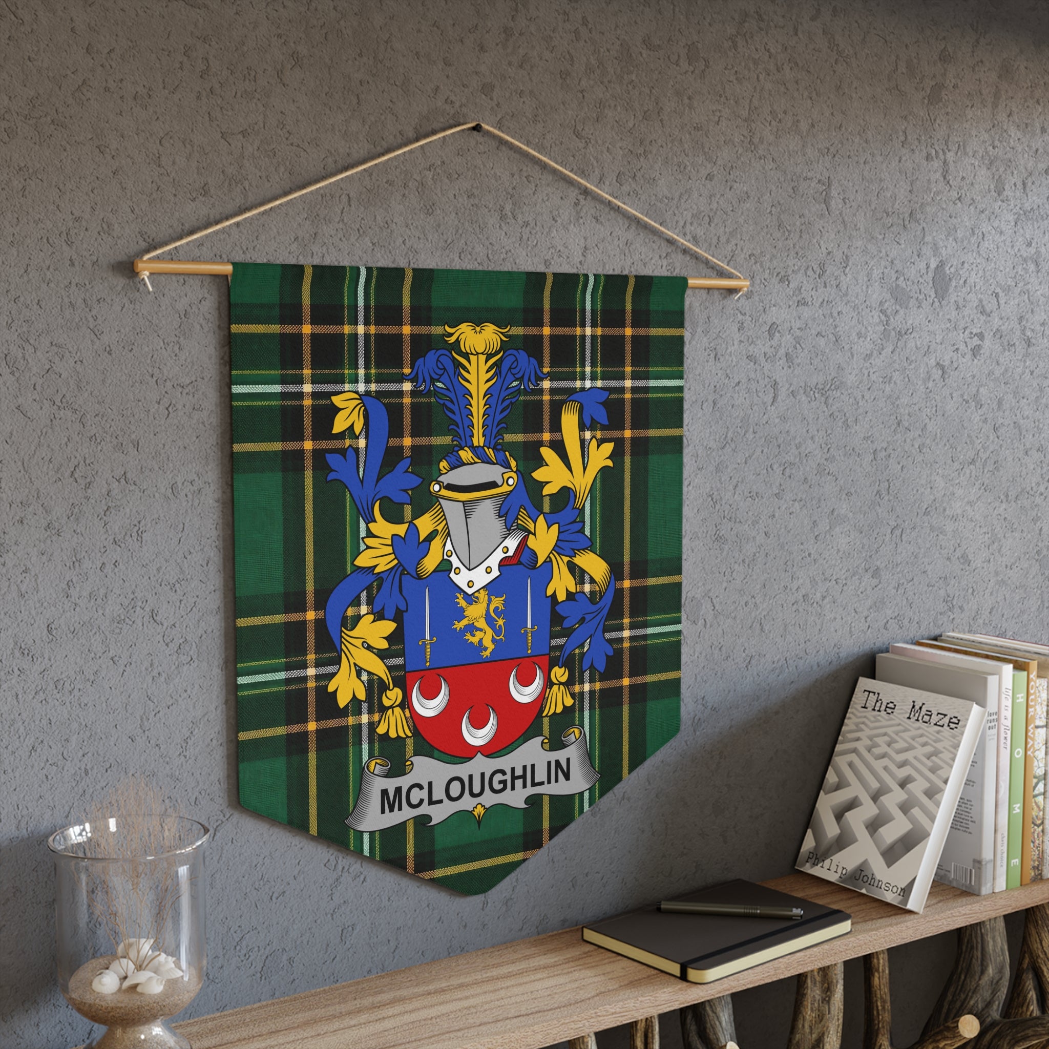 McLoughlin family crest on green tartan pennant banner hanging on wall.