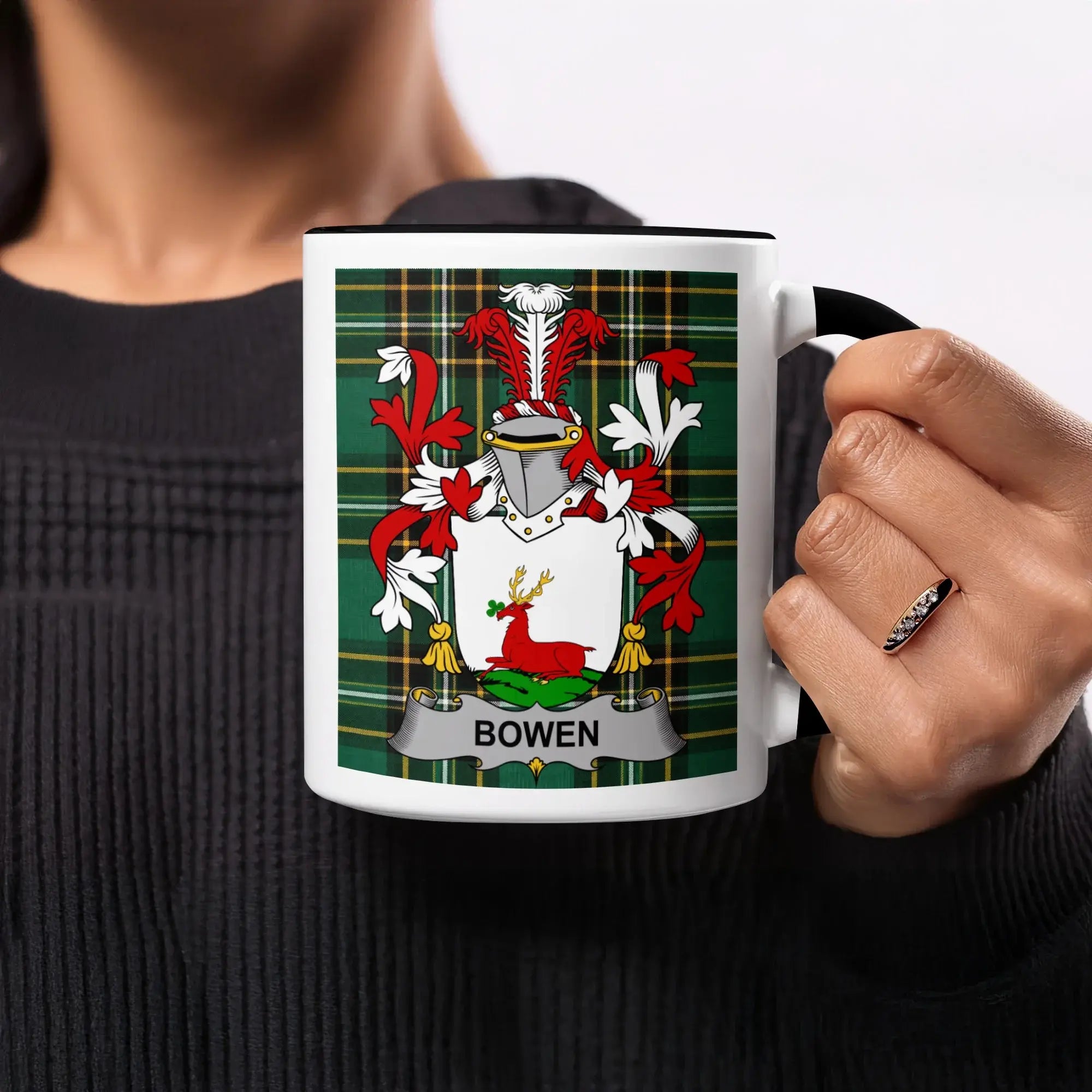 White mug with black trim featuring a tartan pattern and the Bowen coat of arms.