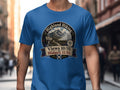 Blue t-shirt with "Highland Hiking" graphic showing mountains, a sign, and a mosquito.