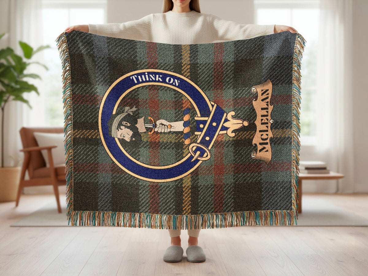 Person holding the McLellan woven blanket to show the full design, tartan background and fringe
