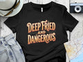 Black t-shirt with "DEEP FRIED AND DANGEROUS" text.