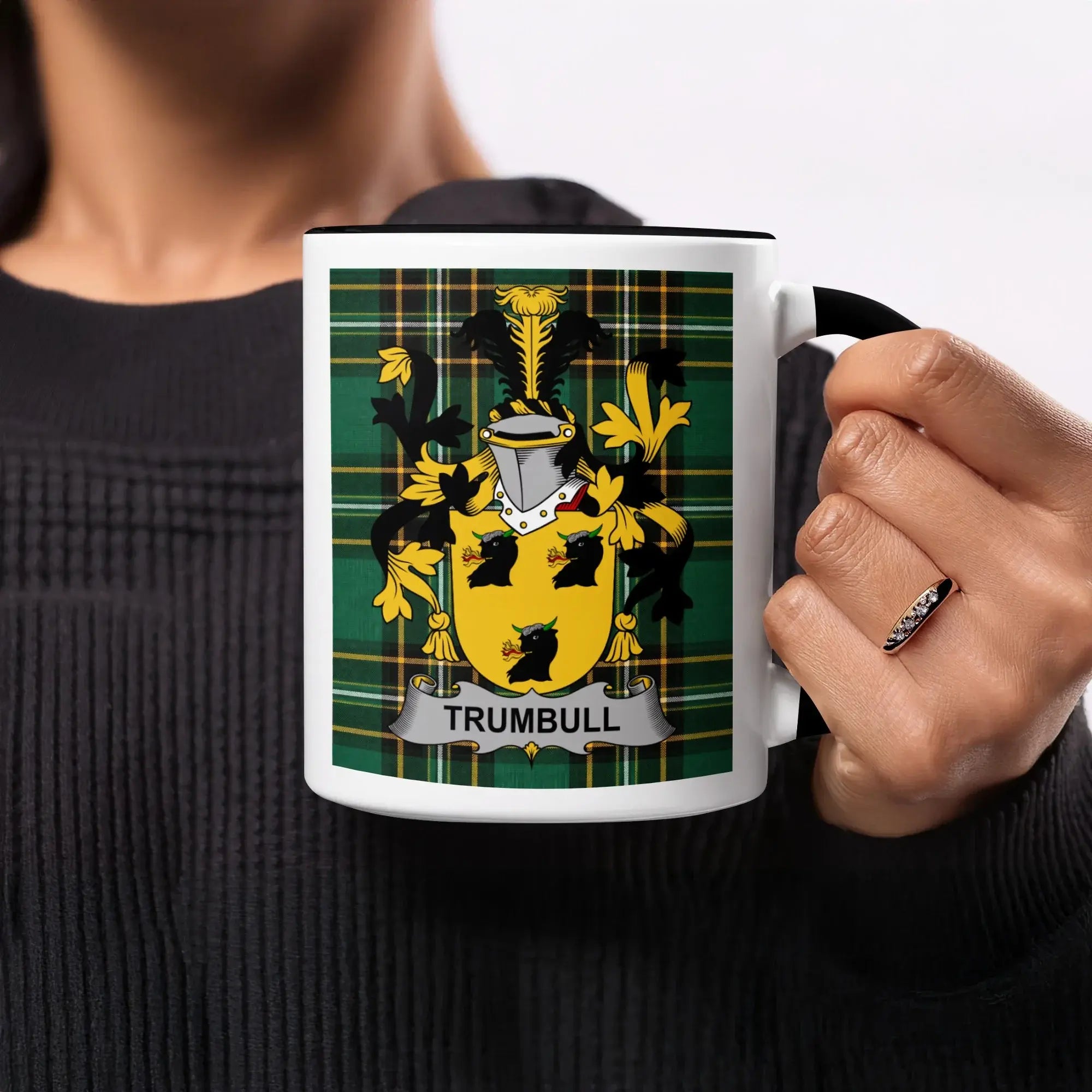 Mug with Trumbull family crest on plaid background.