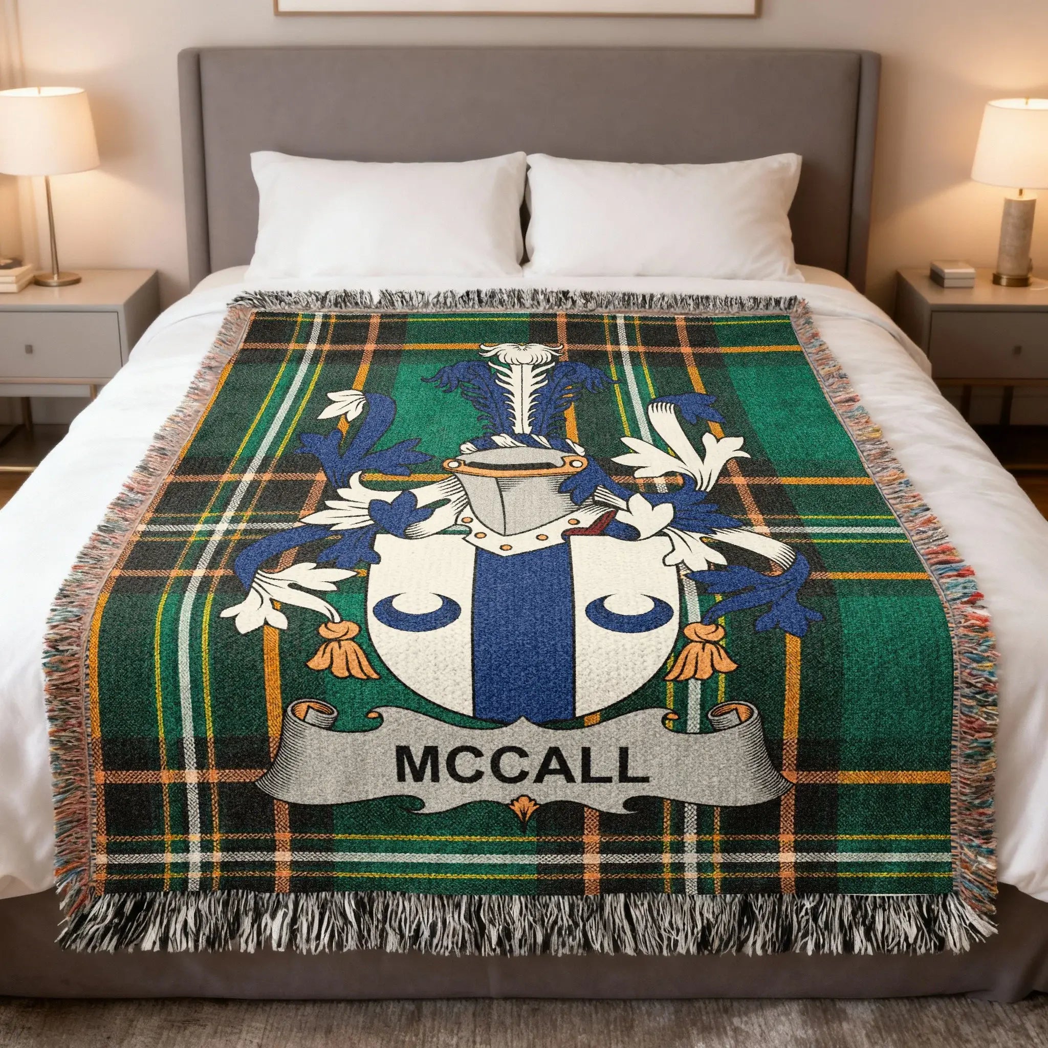 McCall tartan blanket with coat of arms draped on a bed.