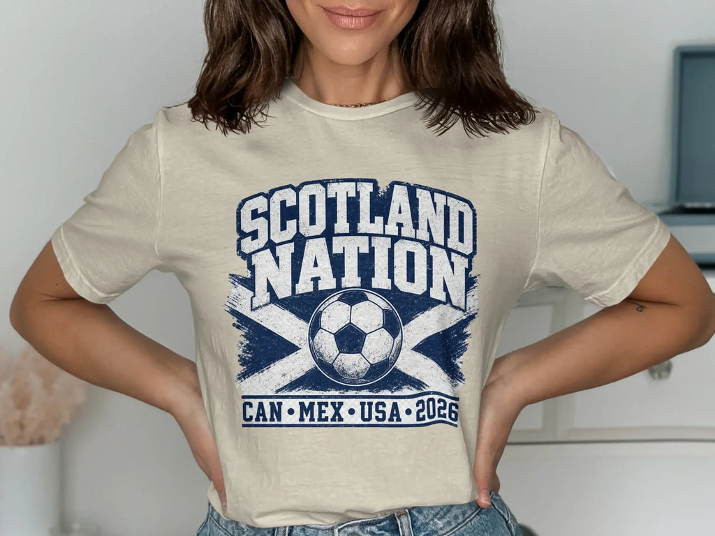 Cream t-shirt with "SCOTLAND NATION" and soccer ball above "CAN MEX USA 2026".